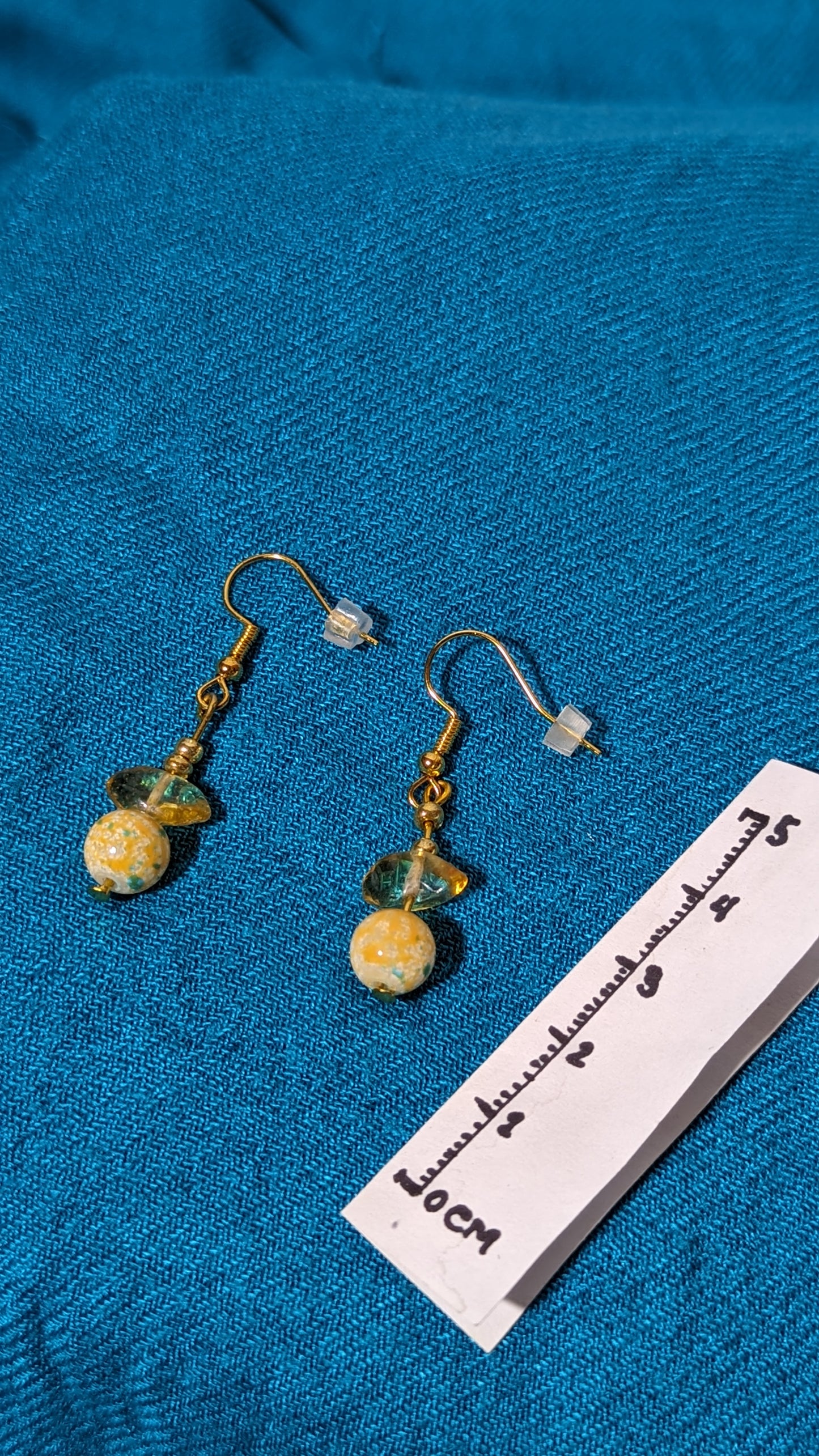 Yellow gem/crystal earrings.