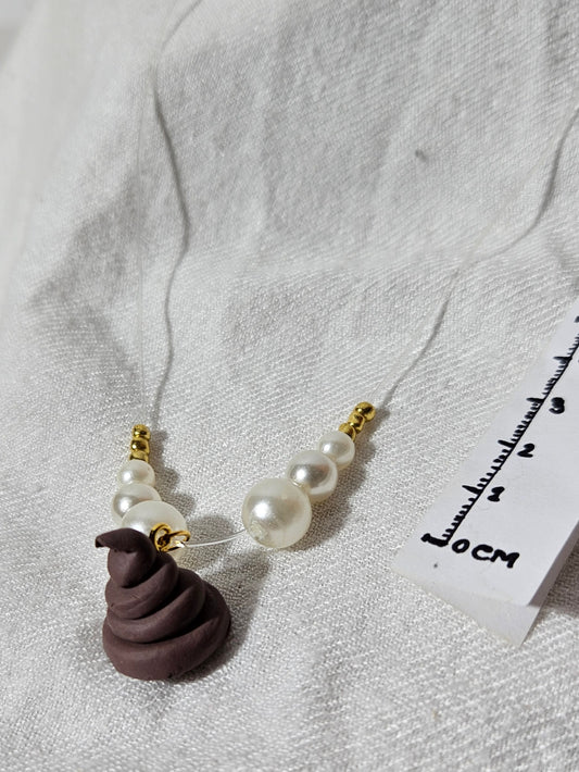 “Luxury poop” necklace