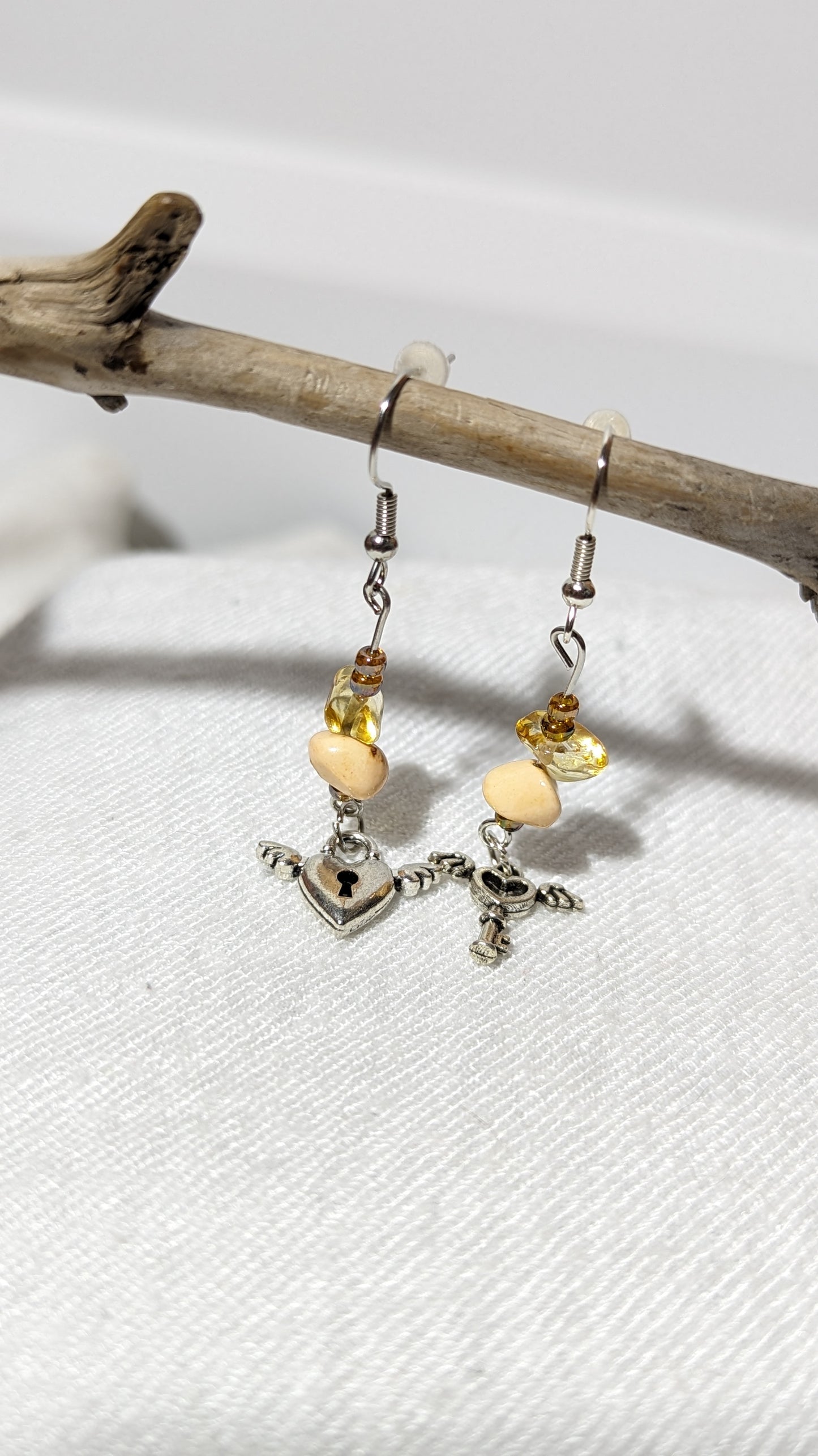 Beige crystal/gem earrings with “Key to the heart” pendant