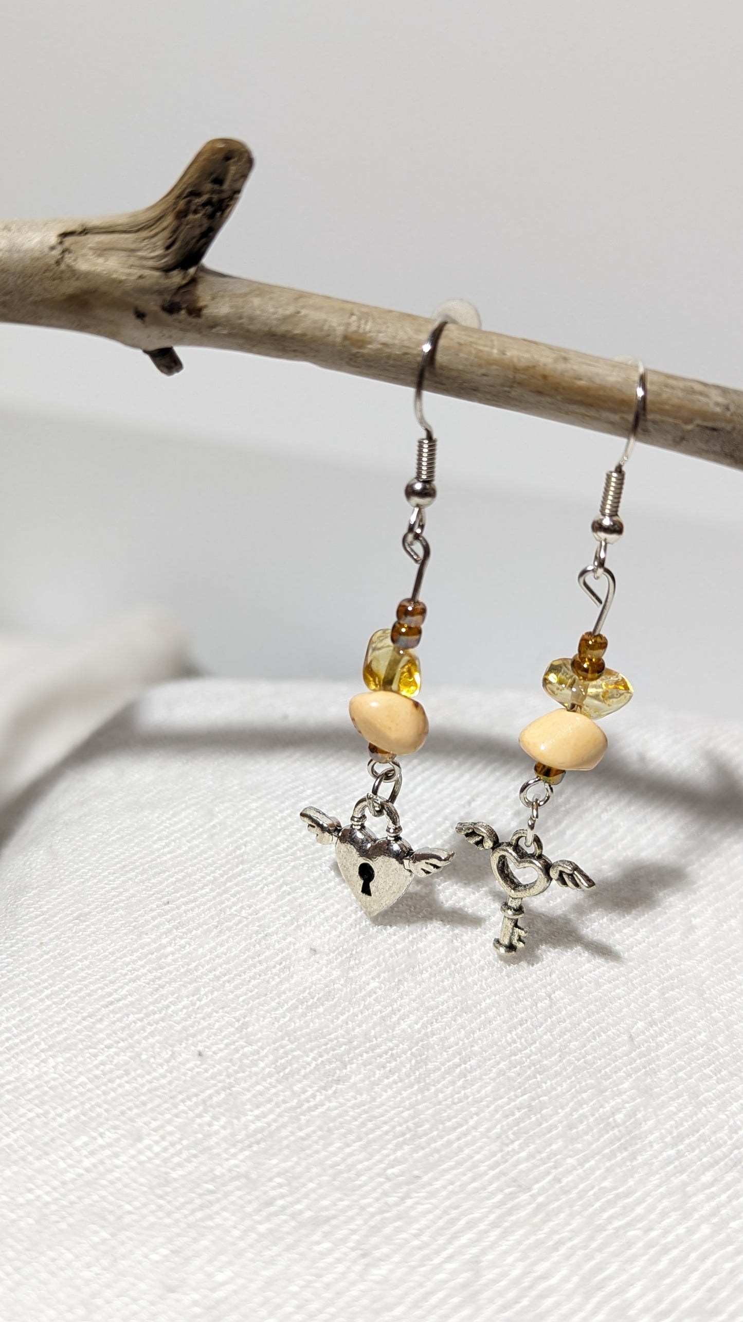 Beige crystal/gem earrings with “Key to the heart” pendant