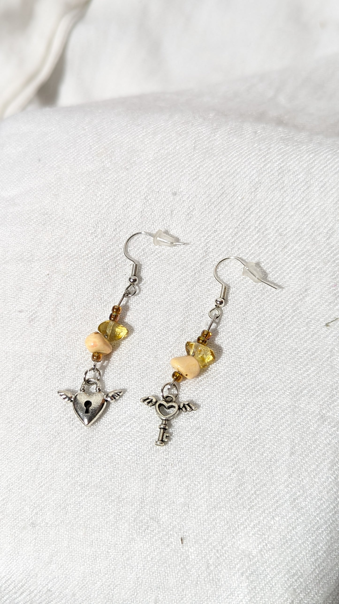 Beige crystal/gem earrings with “Key to the heart” pendant